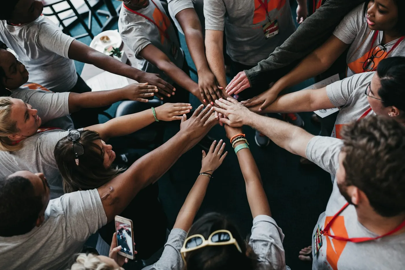Hands joined in the centre of a circle, a sign of shared commitment